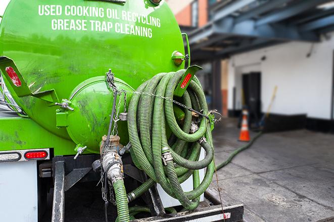 a grease trap being pumped by a sanitation technician in Pacific, WA